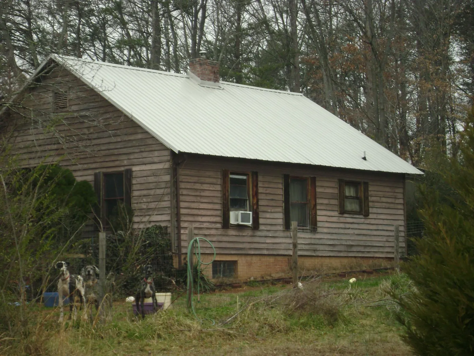 White metal roof on an old wood sided farmhouse, from a Metal Roof Installation job in South Ozone Park